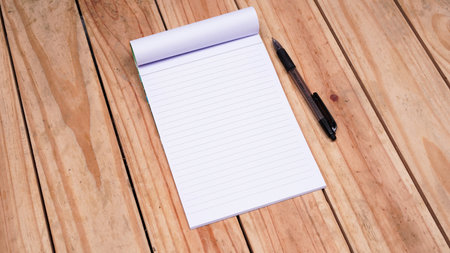 blank white paper notes with pen on top wood tableの写真素材