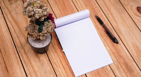 blank white paper notes with edelweis flower and eyeglasses on top wood tableの写真素材