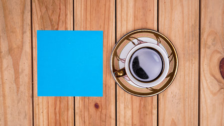 blank blue paper for quotes with coffee on top wood tableの写真素材