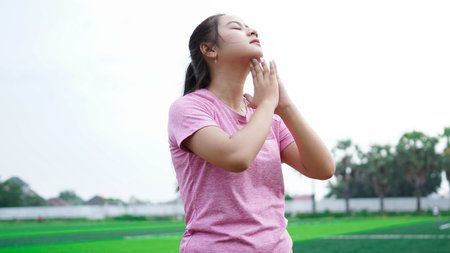 asian woman warming up before running
