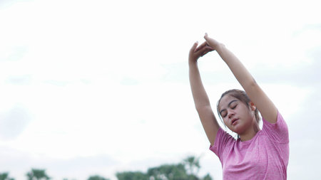asian woman warming up before runningの写真素材
