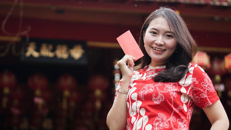 Asian Chinese Women holding ang pao at viharaの写真素材