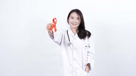 Female doctor holding red cancer awareness ribbonの写真素材