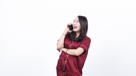woman wearing pajama calling isolated white backgroundの写真素材