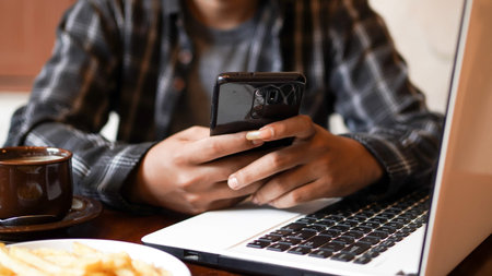 asian business man playing phone at cafe close up