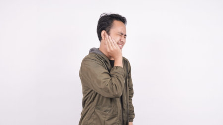 Asian man toothache on a white background