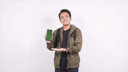 The young man wearing a bag isolated on a white background with greenscreen phone
