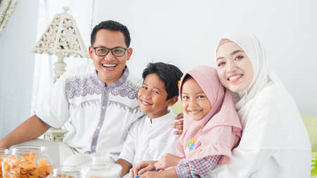 Asian Muslim families celebrate Eid together while enjoying a mealの写真素材