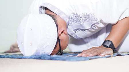 a Muslim family consisting of parents and children movement prostratingの写真素材