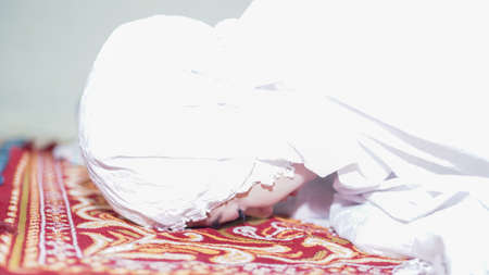 a Muslim family consisting of parents and children movement prostratingの写真素材