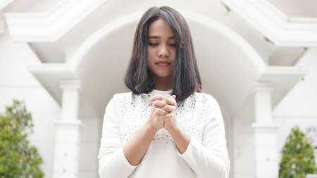 a Christian woman praying humbly in churchの写真素材