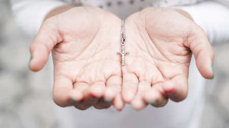 woman hand with a cross and a bibleの写真素材
