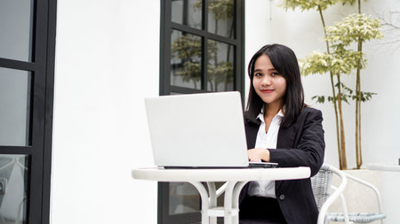 Asian young business woman working on computer in office
