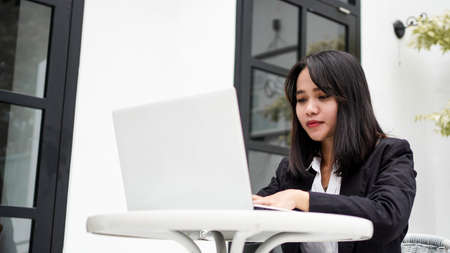 Asian young business woman working on computer in officeの写真素材