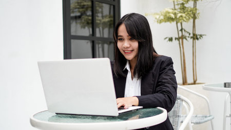 Asian young business woman working on computer in officeの写真素材