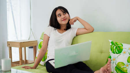 Stressed Asia woman work from home with computer at homeの写真素材