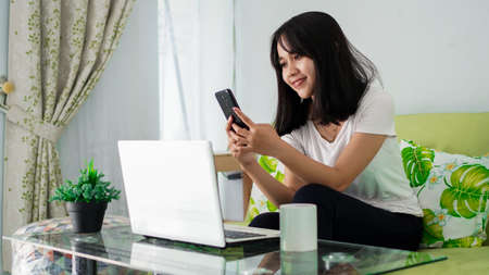 Stressed Asia woman work from home with computer at homeの写真素材