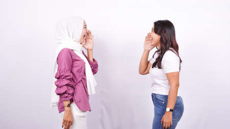 two Asian women screaming expressions isolated white backgroundの写真素材