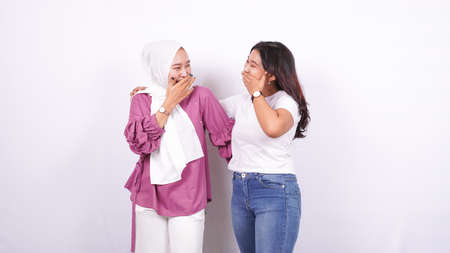 two asian women doing happy expressions isolated white backgroundの写真素材
