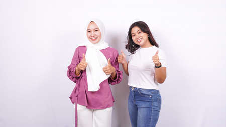 two asian women appreciate something isolated white backgroundの写真素材