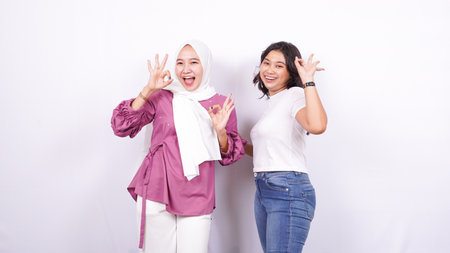 two asian women appreciate something isolated white backgroundの写真素材