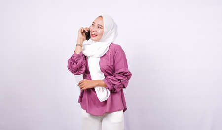 beautiful women hijab speak on the phone isolated white backgroundの写真素材