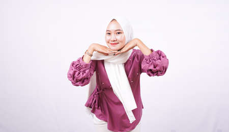 Asian women wear hijab support their chin isolated white backgroundの写真素材