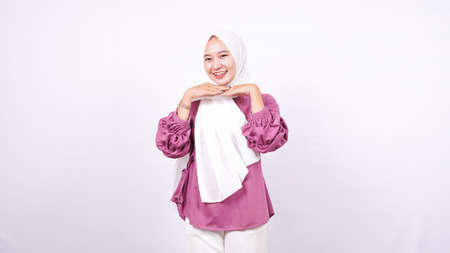 Asian women wear hijab support their chin isolated white backgroundの写真素材
