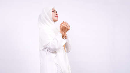 Asian Muslim woman pray isolated white backgroundの写真素材
