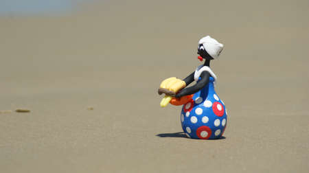 Woman walking on the sand of the beachの写真素材