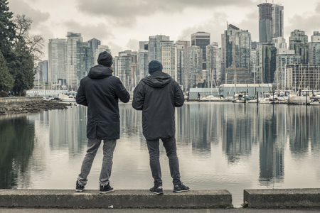 two men enjoying view over vancouver, canadaの写真素材