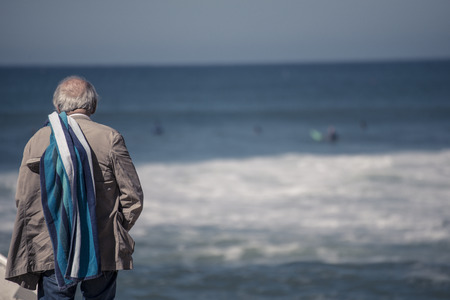 old man checking waves @ hossegor beachの写真素材