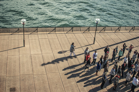 people waiting in front of opera house in sydneyの写真素材