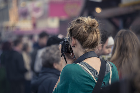 girl taking pictures at Oktorberfestの写真素材
