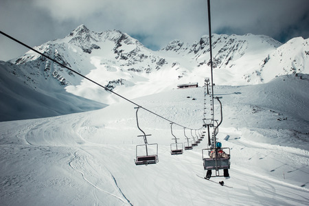 snowboarder alone in the chair liftの写真素材