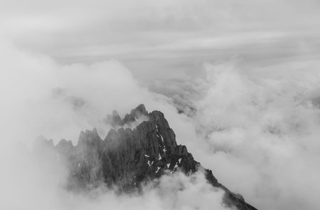 black and white shot of a dark mountain