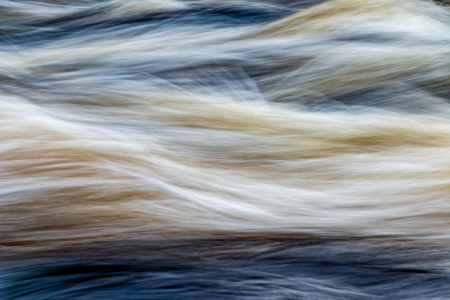 fast moving water in mountain river in swedenの写真素材
