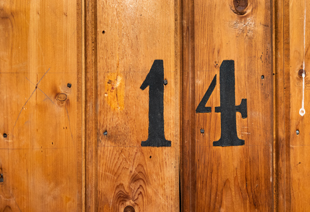 number on door of storage room for tenants in century-old apartment building in stockholmの写真素材