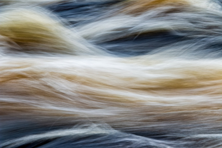 fast moving water in mountain river in swedenの写真素材