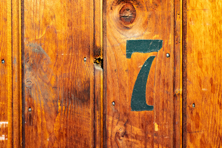 number on door of storage room for tenants in century-old apartment building in stockholmの写真素材