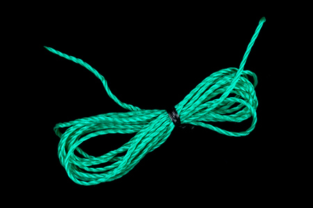 a piece of green string on black backgroundの写真素材