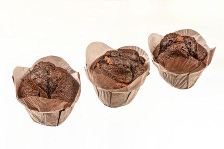 three chocolate muffin cupcake isolated on whiteの写真素材