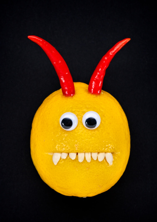 lemon devil face with eyes, chili horns and teethの写真素材