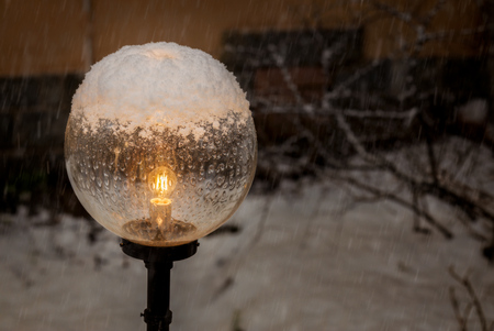 round outdoor lamp in snow in winterの写真素材