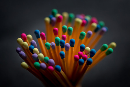 collection of multicolored matches on black backgroundの写真素材