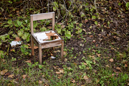 Broken and abandoned chair in forestの写真素材