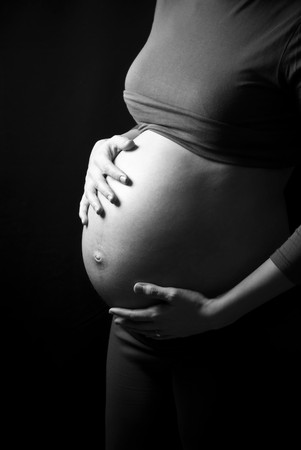 Image of pregnant woman touching her belly with hands の写真素材