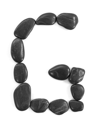 Letter 'G' made of stones isolated on white の写真素材