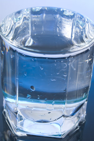glass with water on glossy background 