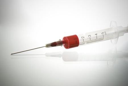 Medical Syringe on glossy background の写真素材